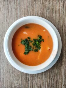 a bowl of soup on a wooden surface